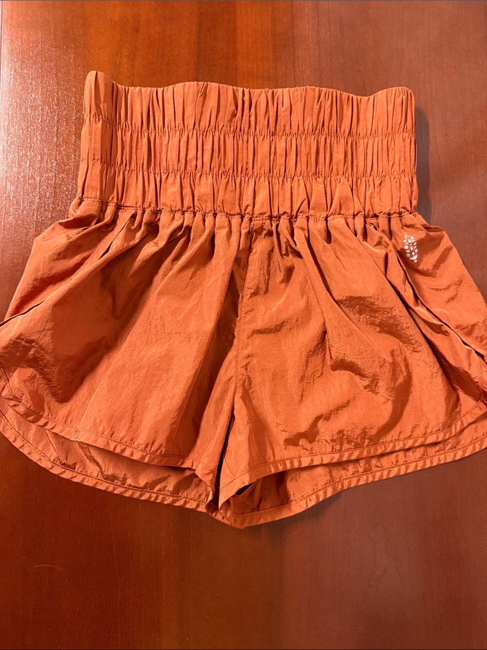 FP Movement by Free People High-Waist Smocked Shorts in Rust Orange